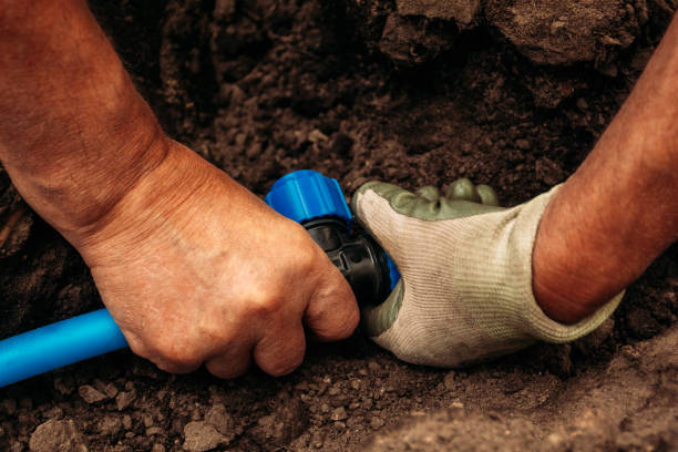istock The hands of the working connecting hose irrigation system 1022663888