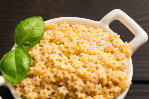 istock Closeup view of raw dry pasta with fresh green basil 1022690806
