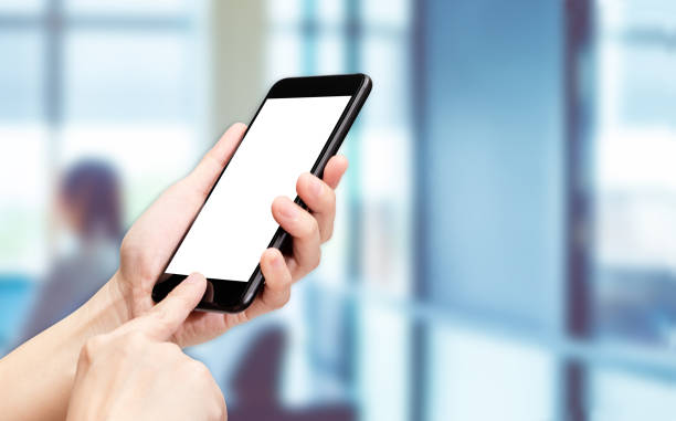 istock Hand click mobile phone with blur office background bokeh light,White screen mock up template for adding your design or your text. 1022696738