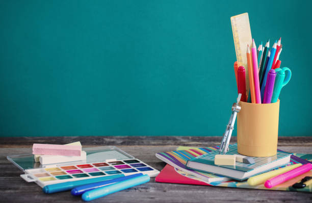 istock school supplies on wooden table on green background 1022710258