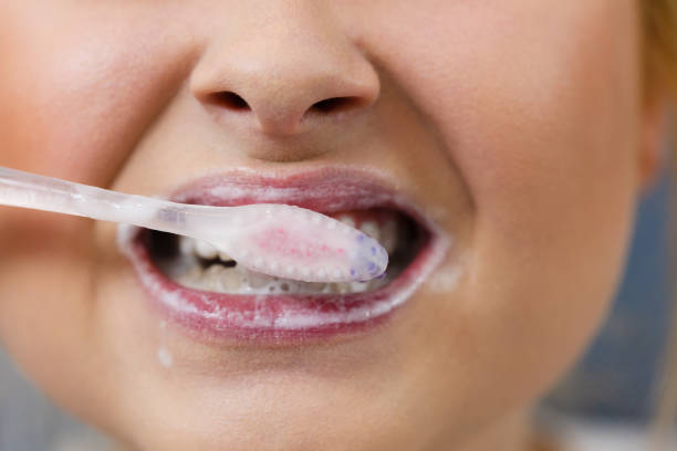 istock Woman brushing cleaning teeth 1022717866
