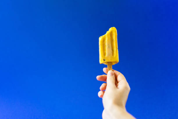 istock Juicy yellow ice cream on a deep blue background. 1022730366
