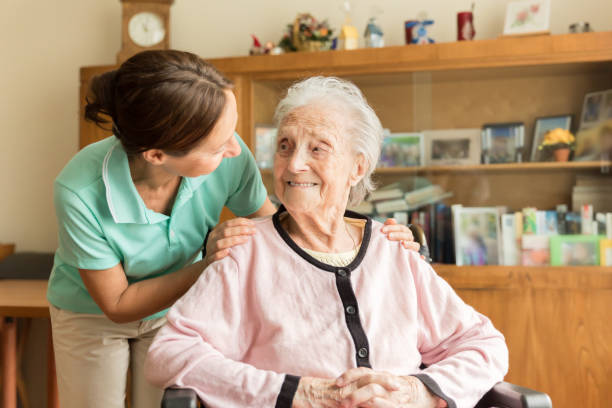 istock Senior woman with home caregiver 1022730404