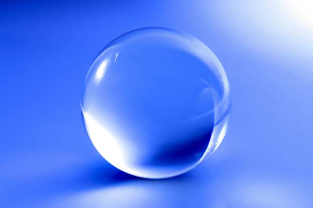 istock Glass ball in abstract blue light 1022730996
