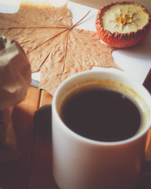 istock Cup of coffee, autumn leaf and dried apple. Selective focus 1022735366