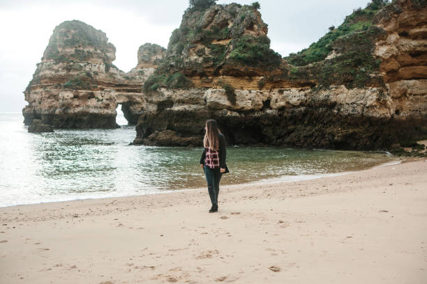 istock Young beautiful girl is walking along the Atlantic coast 1022735738