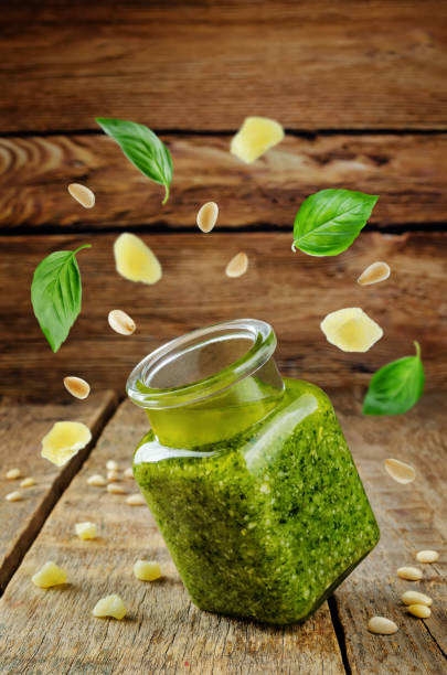 istock Pesto sauce with flying ingredients to prepare it 1022746450