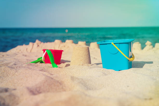 istock kids toys and sandcastle on beach 1022748934