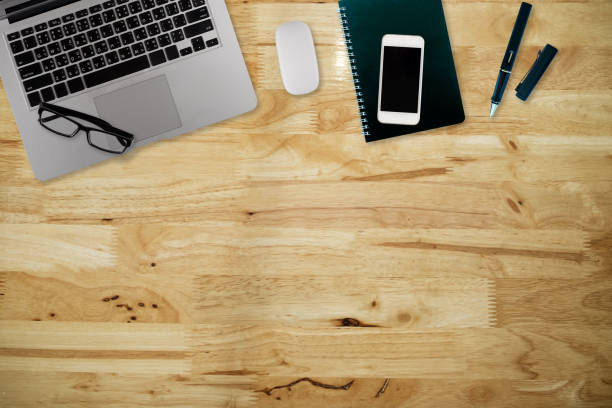 istock Office desk table with computer, supplies,analysis chart, ipad,smartphone,coffee cup on wooden background. Top view with copy space 1022753852
