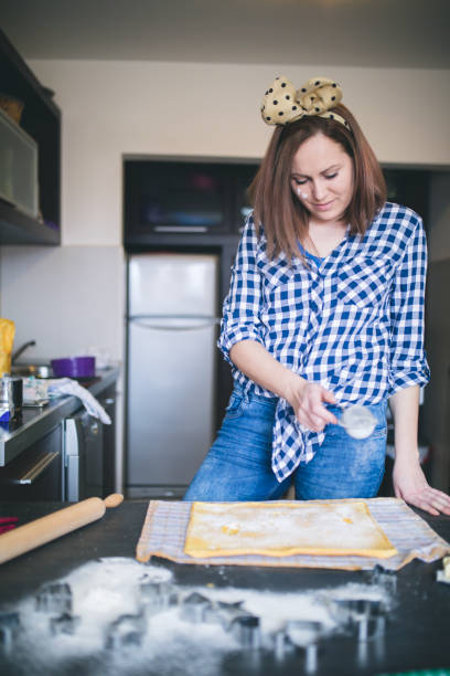 istock Female baker or pastry chef sprinkles powdered sugar. 1022753860