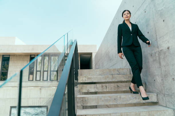 istock business manager walking down from stair 1022759340