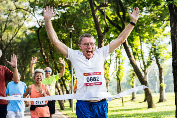 istock Happy senior running through the finish line 1022763404