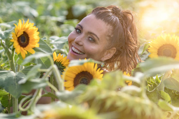istock Woman with sunflowers 1022768614