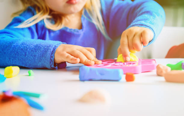 istock Child playing with clay molding shapes 1022775266