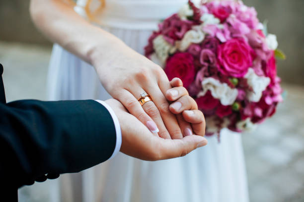 istock women's and men's hands with wedding rings 1022780610