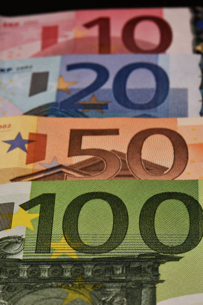 euros (money) scattered on wooden table