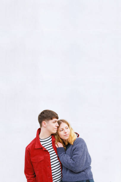 istock young affectionate couple standing in front of concrete wall 1022784604