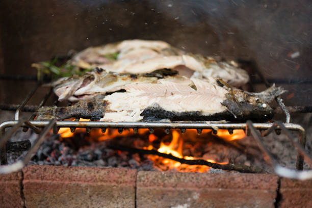 Trout fish freshly caught and ready to cook on wood barbecue.