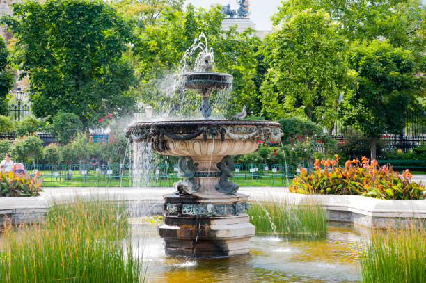 Antique fountain in garden. Water flowing from stone fountain, beauty design.