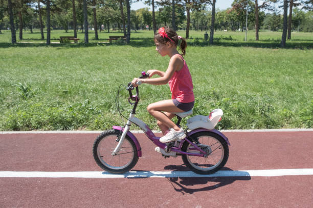 istock Children learning to drive a bicycle on a driveway outside 1022793714