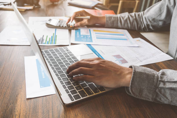 istock Business accounting, Businessman using computer laptop with document and caculator in office, Savings, finances and economy concept. 1022793890