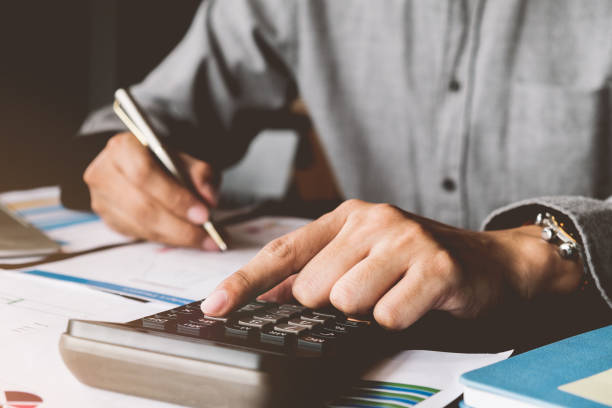 istock Business accounting, Business man using calculator with  budget document,pen and computer laptop and in office, Savings, finances and economy concept. 1022800542