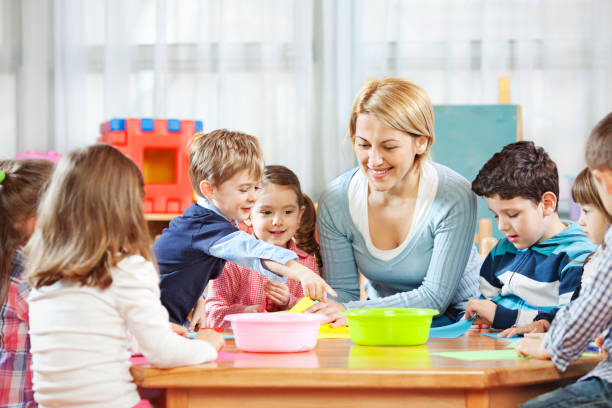istock Teacher talking with children 1022800766