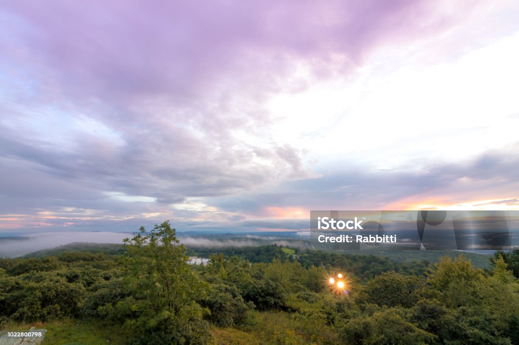 Fog lifts from the Kittany Mountains at sunset Fog lifts from the Kittany Mountains at sunset at High Point State Park, the top of NJ, in mid summer Activity Stock Photo