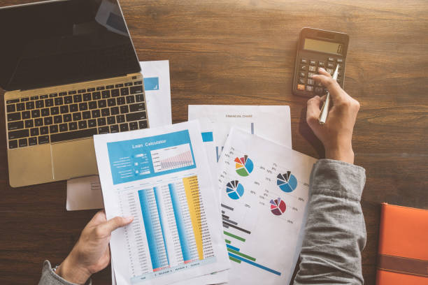 istock Real estate agent working with caculator,laptop and document on wooden table in the office, Loan and Payment Calculators ,Financial Calculators 1022801588