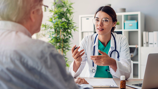 Médico y paciente están discutiendo en la clínica photo