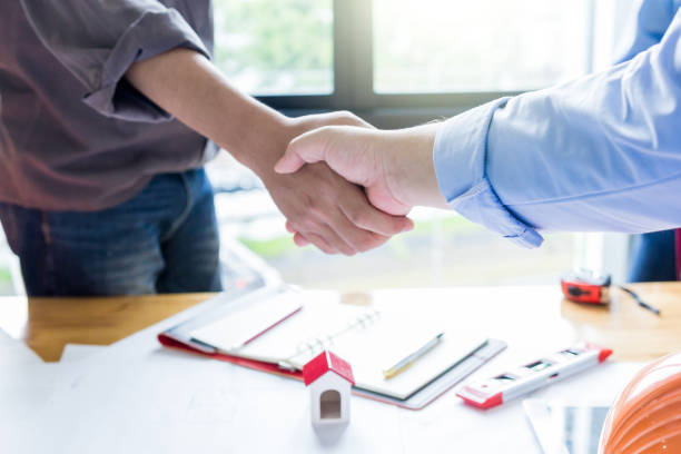 istock Two confident business man shaking hands during a meeting in the architect office. 1022804638