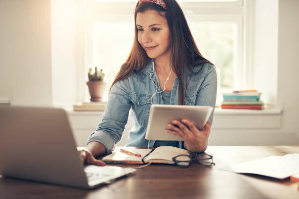 istock Female entrepreneur with tablet browsing laptop in office 1022808204