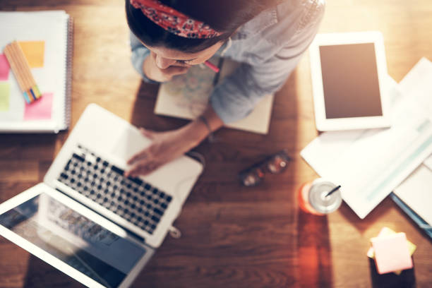 istock Thoughtful young businesswoman browsing laptop at workplace 1022808220