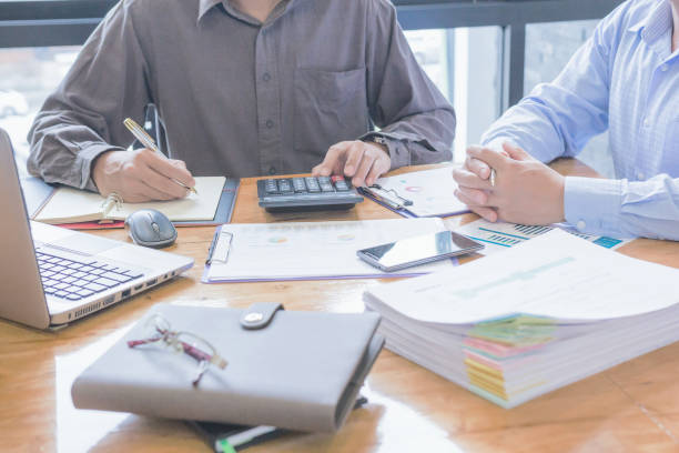 istock Fiinancial inspector making report, calculating or checking balance. 1022808406