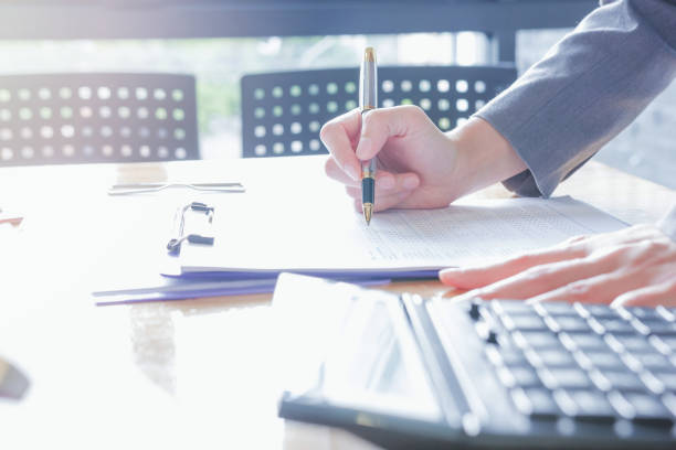 istock Fiinancial inspector making report, calculating or checking balance. 1022808542
