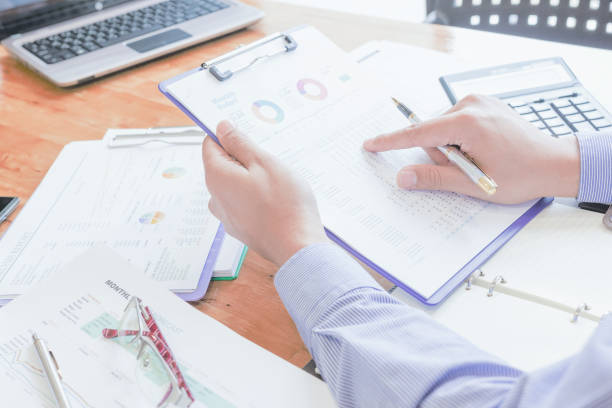 istock Fiinancial inspector making report, calculating or checking balance. 1022809072