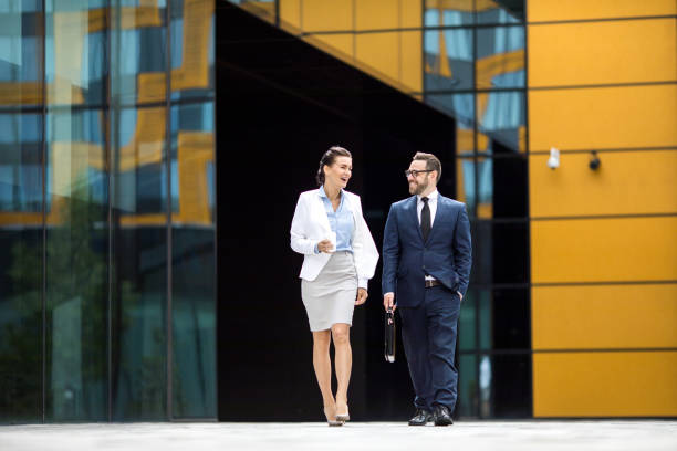 istock Smiling man and woman getting out office building 1022812756