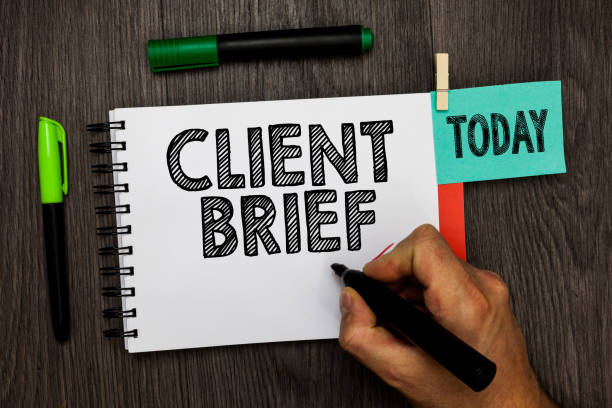 istock Conceptual hand writing showing Client Brief. Business photo showcasing A documents bounded by the terms of clients and the agency Man holding marker notebook reminder cup markers wood table. 1022821034
