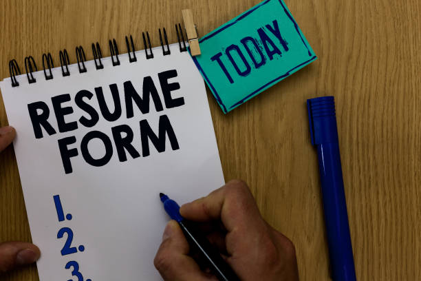 istock Word writing text Resume Form. Business concept for describe the layout elements appearing in written document Man holding marker notebook clothespin reminder wooden table cup coffee. 1022821158