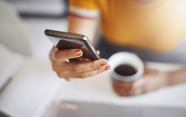 istock She's got her cellphone and coffee, ready for the day 1022823902