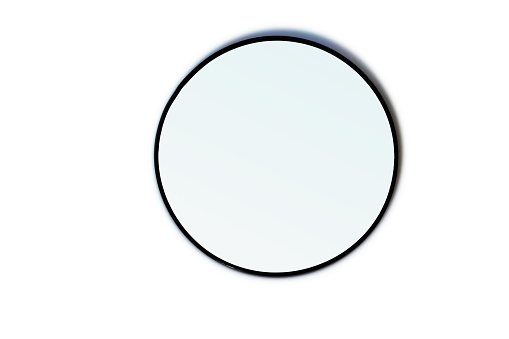 A gradient mirror laying on a white table.