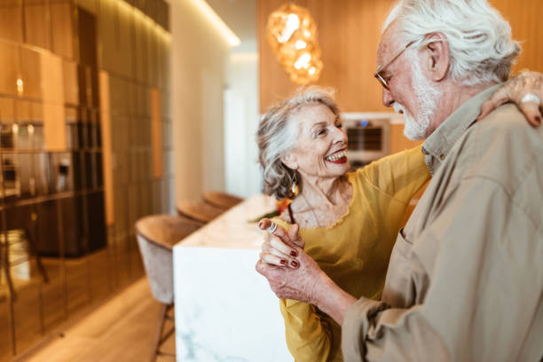 senior couple dancing in the kitchen senior couple dancing in the kitchen middle aged couple dancing stock pictures, royalty-free photos & images