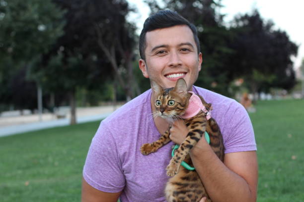 istock Handsome man in the park with his cat 1022828818