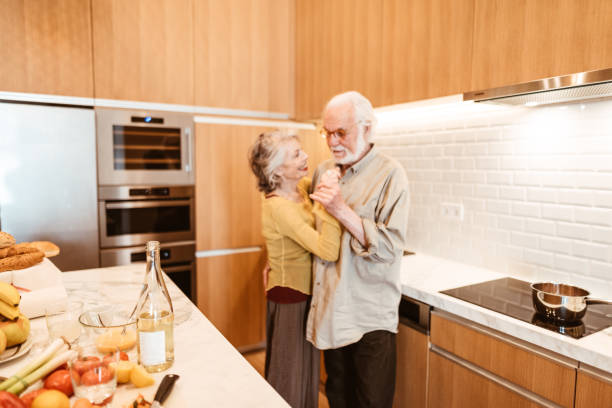 istock senior couple dancing in the kitchen 1022831618