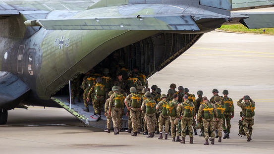 EINDHOVEN, THE NETHERLANDS - SEP 17, 2016: Paratroopers entering a German Air Force C-160 Transall military airplane.