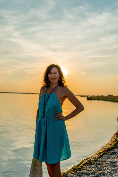 Sunset at the danube with lady in selfmade turquoise dress