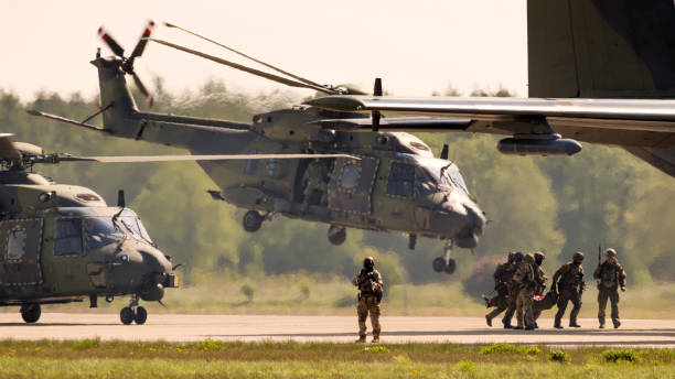 German army soldiers and helicopters in action BERLIN, GERMANY - APR 27, 2018: German military NH90 troop helicopter and special forces performing a military demonstration at the Berlin ILA Air Show. nato stock pictures, royalty-free photos & images