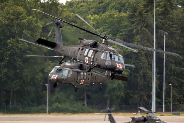 US Army medical Blackhawk helicopters EINDHOVEN, THE NETHERLANDS - JUN 22, 2018: United States Army Sikorsky UH-60 Blackhawk transport helicopters taking off. blackhawk stock pictures, royalty-free photos & images