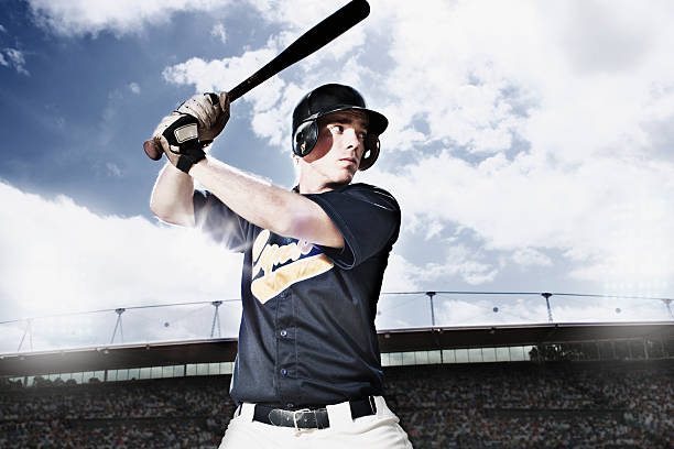 Baseball player swinging baseball bat  baseball hitter stock pictures, royalty-free photos & images