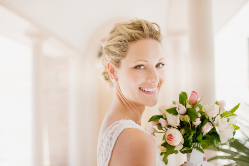 Smiling bride with bouquet